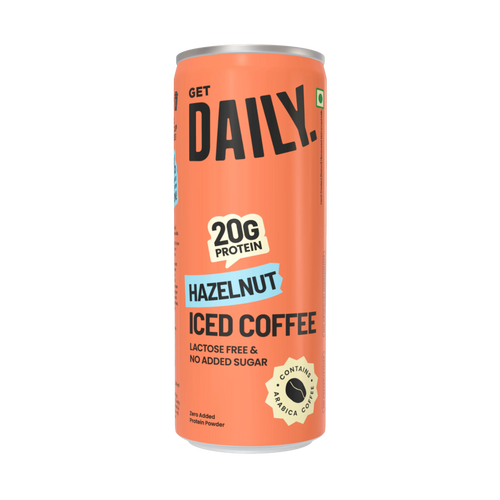 An orange can of Get Daily Hazelnut Iced Coffee protein powder, featuring bold black text, a light blue 'HAZELNUT' banner, and a gold badge indicating 20g protein.
